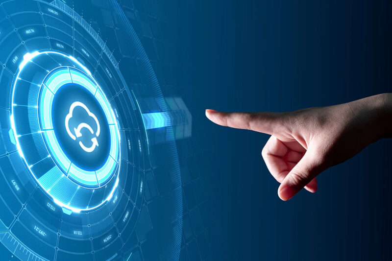 A hand pointing at a digital interface with a cloud icon, illustrating how to integrate cloud solutions with existing IT infrastructure