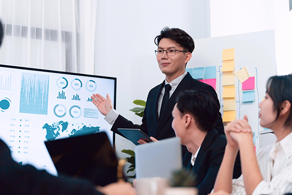A project manager in Singapore conducting a presentation to a team.
