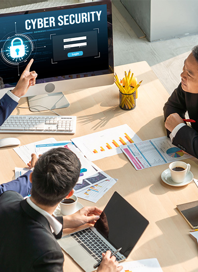 Business professionals discussing Japan IT Security strategies, analyzing reports, and reviewing cybersecurity measures on a computer screen Business professionals discussing Japan IT Security strategies, analyzing reports, and reviewing cybersecurity measures on a computer screen