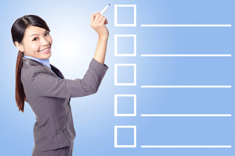 Businesswoman checking a compliance list, ensuring data security Businesswoman checking a compliance list, ensuring data security