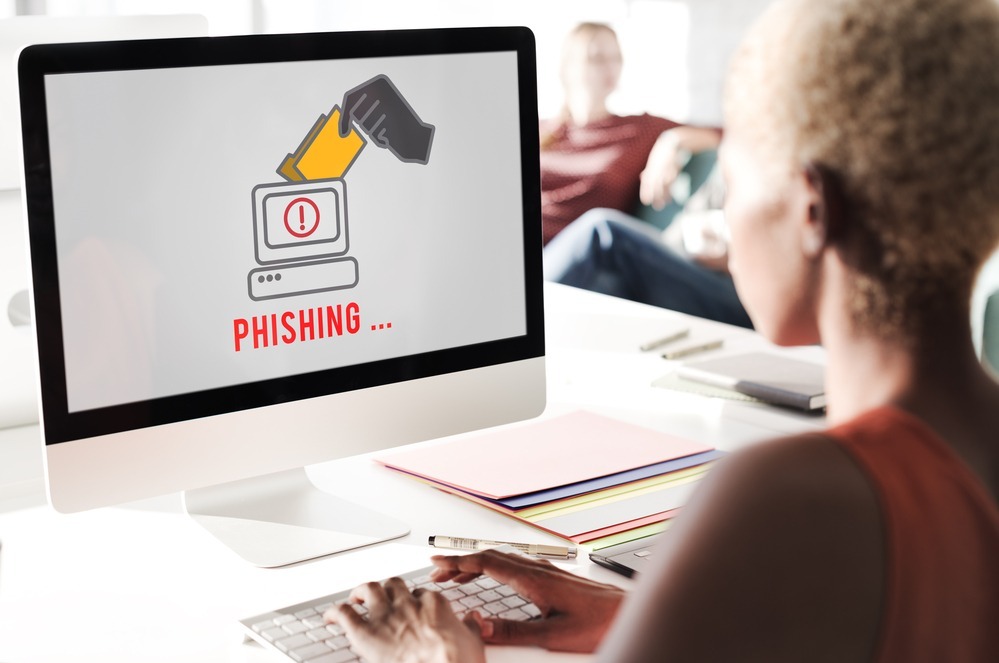 How to Prevent Phishing Emails and Keep Your Business Safe 2 Business Woman Working on Computer That Has a Phishing Threat
