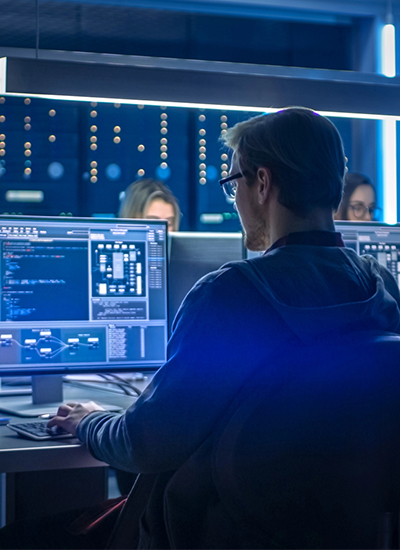 Cybersecurity professional monitoring IT security solutions in Japan, analyzing network data on multiple screens in a secure environment Cybersecurity professional monitoring IT security solutions in Japan, analyzing network data on multiple screens in a secure environment