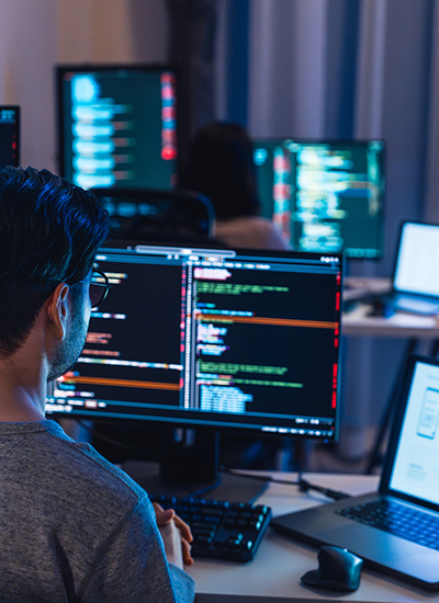 Cybersecurity professionals conducting network penetration testing, analyzing code and security vulnerabilities on multiple screens. Cybersecurity professionals conducting network penetration testing, analyzing code and security vulnerabilities on multiple screens.