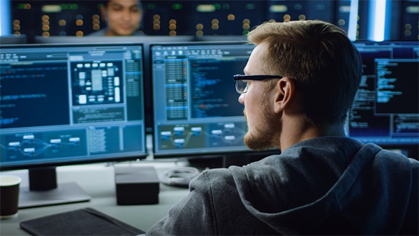 IT security specialists in Hong Kong monitoring the systems to prevent network breach. Cybersecurity expert in Hong Kong monitoring the systems to prevent cyber security incidents.