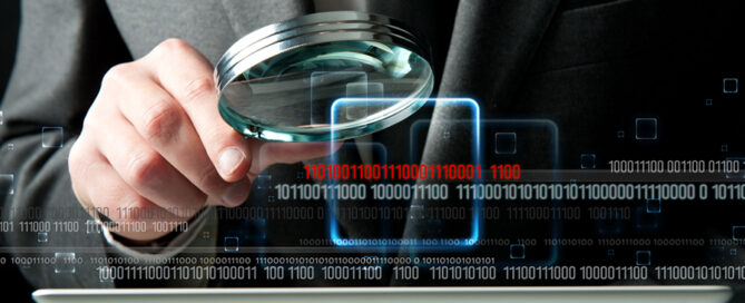 IT specialist examines computer, showcasing what is digital forensics in cybersecurity.
