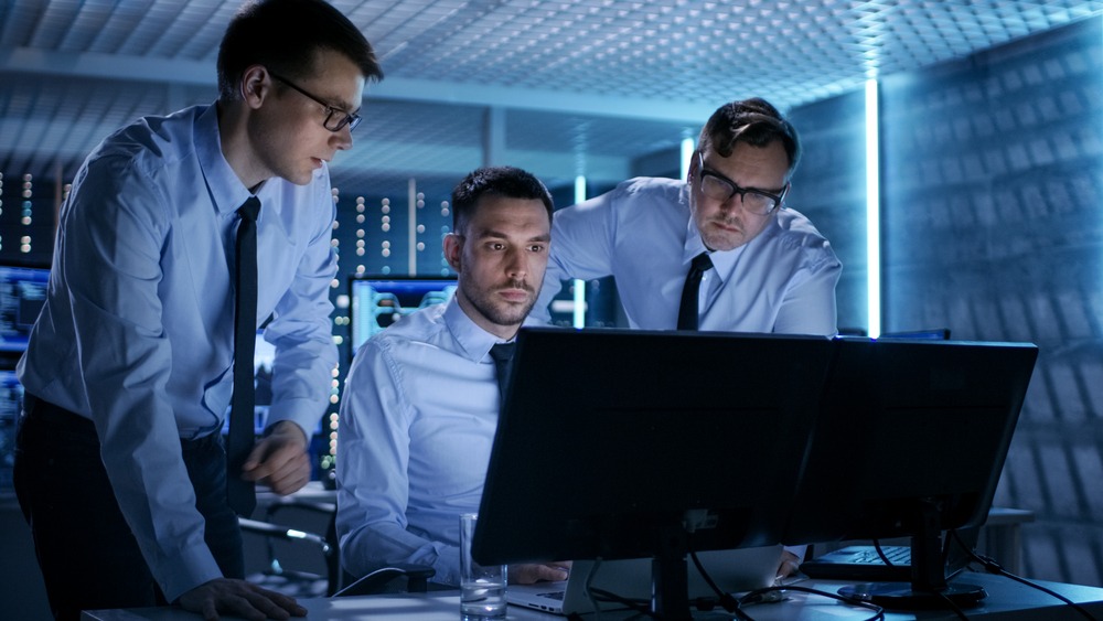 Men discussing IT issues to provide computer support for internal users Professionals at an IT support company monitoring security with rapid response times