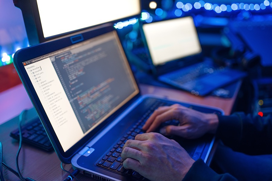 Network penetration testing services Programmer hands on laptop performing network penetration testing services.