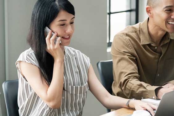 woman on phone looking for IT support in Singapore from EIRE Systems