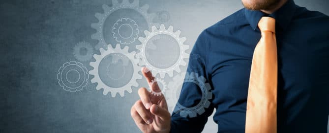 Project manager checking the cog wheels image concept showing the importance of project management in business. Project managers doing proper project management is necessary for a successful project.