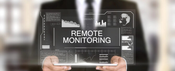 Remote Monitoring and Management concept showing a professional holding a tablet with dashboards, and charts.