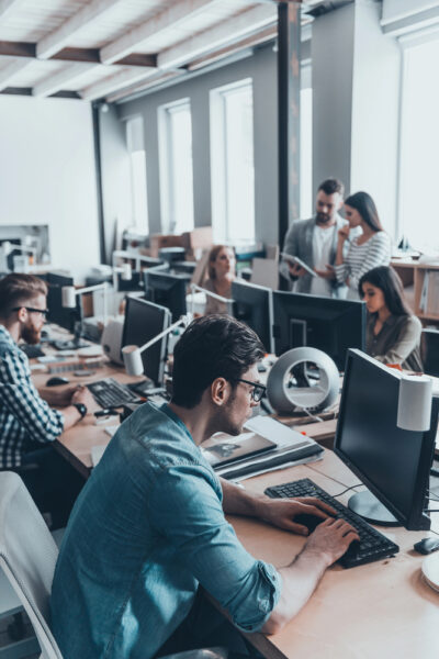 Wi-Fi Assessment Services in Singapore 3 Singaporean business professionals collaborating in an office with optimized and secure Wi-Fi network, ensuring seamless connectivity and increased productivity