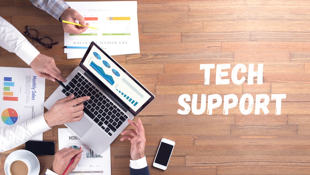 tech support concept with it team working at deak