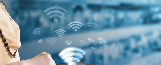 woman using tablet that shows wifi network icon