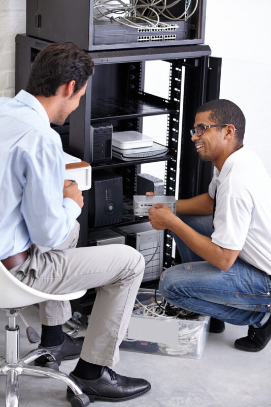 Wi-Fi Assessment Services in Singapore 2 IT technicians in Singapore assessing network infrastructure for Wi-Fi assessment services in Singapore, ensuring optimal performance