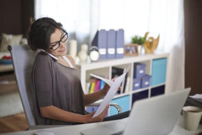 Woman working from home feeling happy